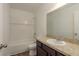 Well-lit bathroom featuring a tub-shower combination and granite-style countertop at 34855 Daisy Meadow Loop, Zephyrhills, FL 33541