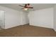 The bedroom features neutral walls, plush carpeting, and a ceiling fan at 34855 Daisy Meadow Loop, Zephyrhills, FL 33541