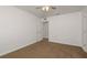 A spacious bedroom offers neutral walls and plush carpeting at 34855 Daisy Meadow Loop, Zephyrhills, FL 33541