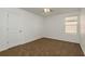 Comfortable bedroom featuring neutral walls, plush carpeting, ceiling fan, and ample natural light at 34855 Daisy Meadow Loop, Zephyrhills, FL 33541