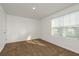 Bright bedroom featuring a large window and plush carpeting at 34855 Daisy Meadow Loop, Zephyrhills, FL 33541