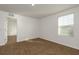 The bedroom features neutral walls, plush carpeting, a window for natural light and walk-in closet at 34855 Daisy Meadow Loop, Zephyrhills, FL 33541