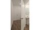 Entryway with luxury vinyl plank flooring, pedestal sink, and entry door with hardware, showcasing a half bathroom at 34855 Daisy Meadow Loop, Zephyrhills, FL 33541