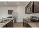 Gleaming kitchen featuring stainless steel appliances, granite countertops, and a center island with double sinks at 34855 Daisy Meadow Loop, Zephyrhills, FL 33541