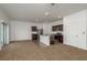 Open-concept living room and kitchen with natural light, kitchen island, stainless appliances, and sliding glass doors at 34855 Daisy Meadow Loop, Zephyrhills, FL 33541