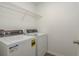 A functional laundry room with modern washer and dryer at 34855 Daisy Meadow Loop, Zephyrhills, FL 33541