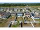 Aerial view showcases a community of well-maintained homes with fenced yards and landscaping at 34866 Daisy Meadow Loop, Zephyrhills, FL 33541