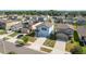A captivating aerial view of a residential neighborhood featuring well-maintained homes and lush landscaping at 34866 Daisy Meadow Loop, Zephyrhills, FL 33541
