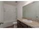Bathroom featuring a shower over bathtub and a sink with granite countertop at 34866 Daisy Meadow Loop, Zephyrhills, FL 33541