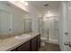 Bathroom featuring a vanity with a sink, a walk-in shower with glass doors, and a toilet at 34866 Daisy Meadow Loop, Zephyrhills, FL 33541
