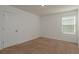 Cozy bedroom with carpet flooring, a window for natural light and white walls at 34866 Daisy Meadow Loop, Zephyrhills, FL 33541