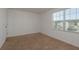 A bright bedroom with carpet flooring, a window for natural light and white walls at 34866 Daisy Meadow Loop, Zephyrhills, FL 33541