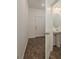 Inviting foyer featuring wood-look floors, a half bath, and a front door with modern hardware at 34866 Daisy Meadow Loop, Zephyrhills, FL 33541