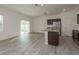 Spacious kitchen featuring stainless steel appliances, dark wood cabinets, a center island, and vinyl flooring at 34866 Daisy Meadow Loop, Zephyrhills, FL 33541