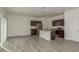 Open kitchen featuring stainless steel appliances, dark wood cabinets, an island, and vinyl flooring at 34866 Daisy Meadow Loop, Zephyrhills, FL 33541