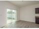 Bright living room featuring wood floors, natural light from sliding glass doors, and neutral paint at 34866 Daisy Meadow Loop, Zephyrhills, FL 33541