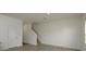 Spacious living room showcasing access to the staircase, vinyl flooring, and abundant natural light at 34866 Daisy Meadow Loop, Zephyrhills, FL 33541