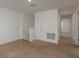 Carpeted loft area with neutral walls, natural light, and a hallway leading to other rooms at 34866 Daisy Meadow Loop, Zephyrhills, FL 33541