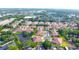 Picturesque aerial view of a residential community featuring well-maintained homes, lush landscaping, and a serene pond at 3707 Orangepointe Rd, Valrico, FL 33596