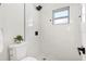 Bright bathroom featuring a modern shower, sleek fixtures and white tiled walls at 3707 Orangepointe Rd, Valrico, FL 33596