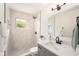 Updated bathroom featuring a walk-in shower, modern vanity, and stylish fixtures at 3707 Orangepointe Rd, Valrico, FL 33596