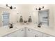 Bright bathroom featuring dual sinks, quartz countertop, and modern fixtures at 3707 Orangepointe Rd, Valrico, FL 33596