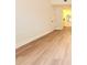Bedroom with wood flooring, white walls and baseboards, and an ensuite bathroom at 3707 Orangepointe Rd, Valrico, FL 33596