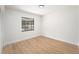 Empty Bedroom featuring wood flooring, white walls, baseboard trim and a window at 3707 Orangepointe Rd, Valrico, FL 33596
