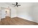 Spacious bedroom with a high ceiling, a fan, wood flooring and a doorway to a bathroom at 3707 Orangepointe Rd, Valrico, FL 33596