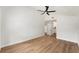 Spacious bedroom with a high ceiling, a fan, wood flooring and a doorway to a bathroom at 3707 Orangepointe Rd, Valrico, FL 33596