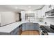 Bright kitchen with white and gray cabinets, stainless steel appliances, and quartz countertops at 3707 Orangepointe Rd, Valrico, FL 33596