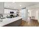 Modern kitchen with white cabinets, stainless steel appliances, granite countertops and hardwood floors at 3707 Orangepointe Rd, Valrico, FL 33596