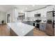 Bright kitchen with white and gray cabinets, stainless steel appliances, and quartz countertops at 3707 Orangepointe Rd, Valrico, FL 33596