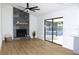 Living room featuring a fireplace, fan, and sliding glass door at 3707 Orangepointe Rd, Valrico, FL 33596