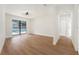 Bright living room featuring hardwood floors and a large window with a view of the pool at 3707 Orangepointe Rd, Valrico, FL 33596