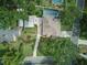 Aerial view of a home with a long driveway and large backyard, showcasing its roof and surrounding greenery at 4101 Brooke Dr, Valrico, FL 33594