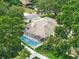 Aerial view showcasing a screened-in pool, white fencing, and lush surrounding greenery for backyard privacy at 4101 Brooke Dr, Valrico, FL 33594