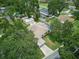 Aerial view of a property with a pool and screened-in lanai surrounded by mature trees at 4101 Brooke Dr, Valrico, FL 33594