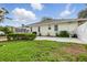 A lush, green backyard featuring a screened-in patio, well-maintained lawn, and privacy landscaping at 4101 Brooke Dr, Valrico, FL 33594