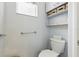 Cozy bathroom featuring a toilet and storage shelves at 4101 Brooke Dr, Valrico, FL 33594