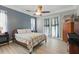 Comfortable bedroom with french doors, ceiling fan, and lots of natural light at 4101 Brooke Dr, Valrico, FL 33594