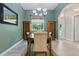 Dining room showcases wooden table, two cabinets and large window at 4101 Brooke Dr, Valrico, FL 33594