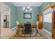 Elegant dining room features a chandelier, wooden table, and view into kitchen at 4101 Brooke Dr, Valrico, FL 33594