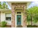 Welcoming front door with brick pillars, a teal door, and a small palm tree at 4101 Brooke Dr, Valrico, FL 33594