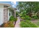 Charming home featuring a brick walkway through lush, colorful landscaping leading to the front door at 4101 Brooke Dr, Valrico, FL 33594