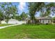 Beautiful home with a large front yard, mature trees, and a white picket fence for added charm and privacy at 4101 Brooke Dr, Valrico, FL 33594