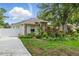 Beautiful home with well-manicured lawn and lush, colorful landscaping complemented by a white picket fence at 4101 Brooke Dr, Valrico, FL 33594