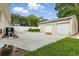 A detached two-car garage featuring a convenient driveway and well-kept lawn at 4101 Brooke Dr, Valrico, FL 33594