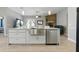 The kitchen has stainless steel sink, white cabinets and countertops, and is open to a living area with fireplace at 4101 Brooke Dr, Valrico, FL 33594