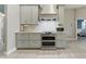 Modern kitchen boasts gray cabinets, stainless steel appliances, and a view to an adjoining room at 4101 Brooke Dr, Valrico, FL 33594